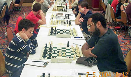Kimani Stancil (right) playing (now GM) Fabiano Caruana at the 2004 World Open (Stancil won). Photo by Daaim Shabazz.