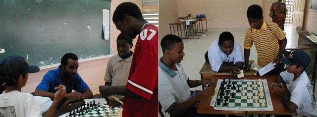 Rohan Waithe and Treey Farley assist with game analysis. Copyright © 2002, Barbados Chess Federation.