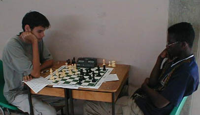 Allan Munro (TRI) vs. Justin Kirton (BAR) in a crucial  7th round match. Copyright © 2002, Barbados Chess Federation.