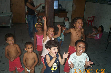 Children cheering each flash of camera. Copyright © 2005, Daaim Shabazz.