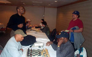 Frank Johnson (seated left) blitzing with Kent Williams while John Porter (standing left) chats with Tyrone Lee. Copyright © 2003, Daaim Shabazz