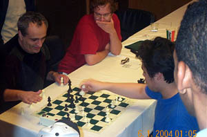 GM Dmitry Gurevich tries Nakamura and swindles the young phenom for a draw. FM Stephen Muhammad (right) looks on. Copyright  2004, Daaim Shabazz