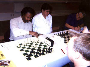 Maurice Ashley on the move against GM Nick deFirmian. Copyright © Daaim Shabazz, 2002.