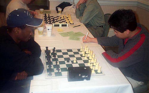 IM Amon Simutowe vs. GM Hikaru Nakamura. Copyright  Daaim Shabazz, 2003.