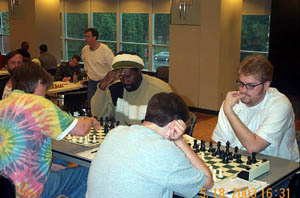 Finale! Boards 3-4: Andy Reeder vs. Todd Andrews (0-1) - foreground; Mark Hosher vs. Negash Bezaleel (0-1). Copyright © 2003, Daaim Shabazz