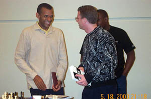 Muhammad shares light moment with Benjamin and Sulaiman Smith after winning the title. Copyright © 2003, Daaim Shabazz
