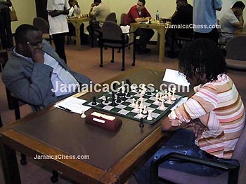 Duane Rowe with a Fischer pose vs. Women's Champion, Deborah Richards. Copyright  2004, JamaicaChess.com