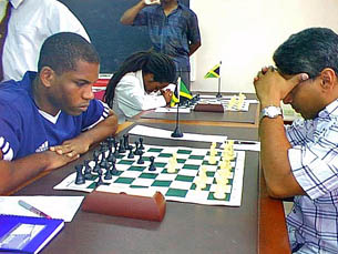 National Master Duane Rowe (left) makes his move against FIDE Master Warren Elliott, in the feature match of round 1 of the 2005 LASCO Chess Championships on Sunday. The match ended in a draw.