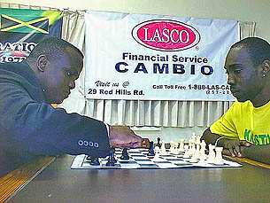 National Master Duane Rowe (left) makes his move against FIDE Master Warren Elliott, in the feature match of round 1 of the 2005 LASCO Chess Championships on Sunday. The match ended in a draw.