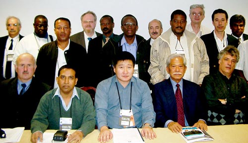 Some of participants in the CACDEC meetings. Standing directly in the center is Daniel Nsibambi (Uganda). Standing second from the right is Allan Herbert (Barbados), who was named Co-Chairman of CACDEC. Copyright © Jerry Bibuld, 2002.