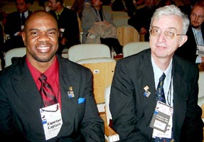 Ian Wilkinson (JAM), Captain of both teams, at left; Robert Wheeler (JAM), secretary of the JAM Chess Federation, player, and FIDE delegate. Copyright  Jerry Bibuld, 2002.