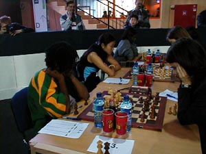 Jamaican Women in Round #1
(L-R) Deborah Richards, Zhu Hui, Vanessa Thomas. Copyright  Barbados Chess Federation, 2002.