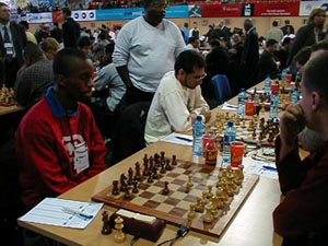 FM Ryan Harper and NM Yogi Ramsingh (TRI) vs. Moldova (MDA). Copyright  Barbados Chess Federation, 2002.