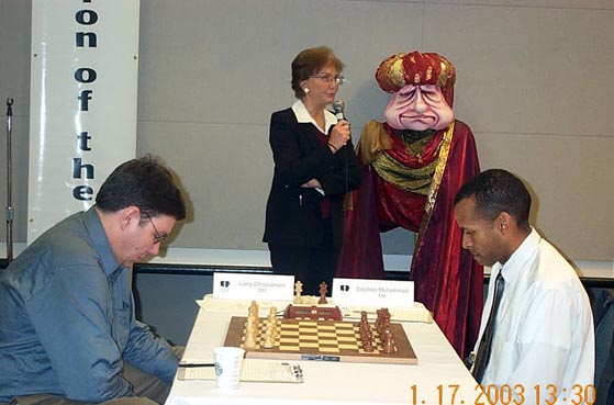 GM Larry Christiansen and FM Stephen Muhammad prepare Rd. 8 face off. Arbiter Carol Jarecki sounds the gong. Copyright  2003, Daaim Shabazz.