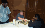 IM John Donaldson (seated left) analyzing his game with NM "Pete" Rogers while NM Glenn Bady observes.