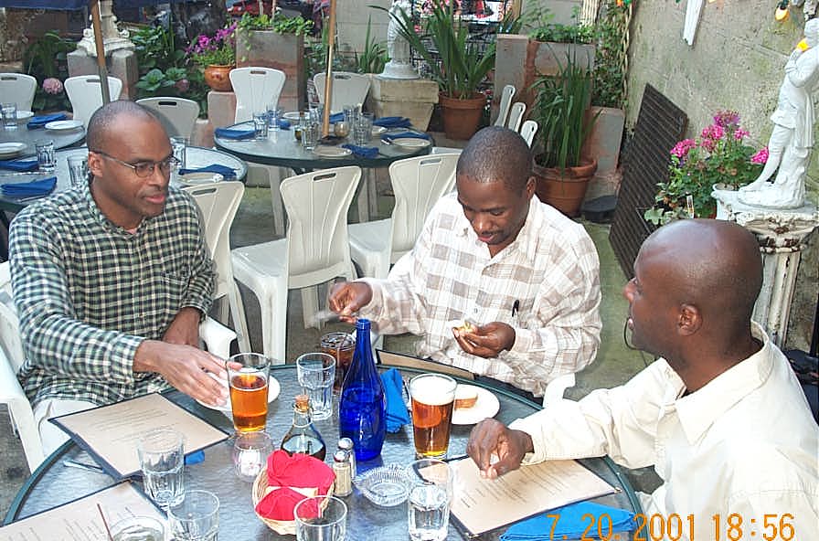 IM Michael Schleifer (Canada), NM Grace Nsubuga (Uganda) and Jerald Times (US) fraternizing at the players dinner. Copyright , Daaim Shabazz.