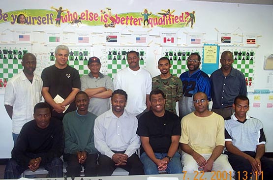 	
Wilbert Paige Memorial players and commentators. Seated (L-R) IM Amon Simutowe, NM Grace Nsubuga, GM Maurice Ashley (commentator),  FM Ronald Simpson, IM Michael Schleifer, FM Stephen Muhammad. Standing (L-R) NM Jerold Times (commentator), NM Ernest Colding,  IM Watu Kobese, FM William Morrison, FM Kenny Solomon, NM Norman Rogers, NM Elvin Wilson (commentator).