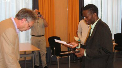 Amon Simutowe receiving his norm certificate.