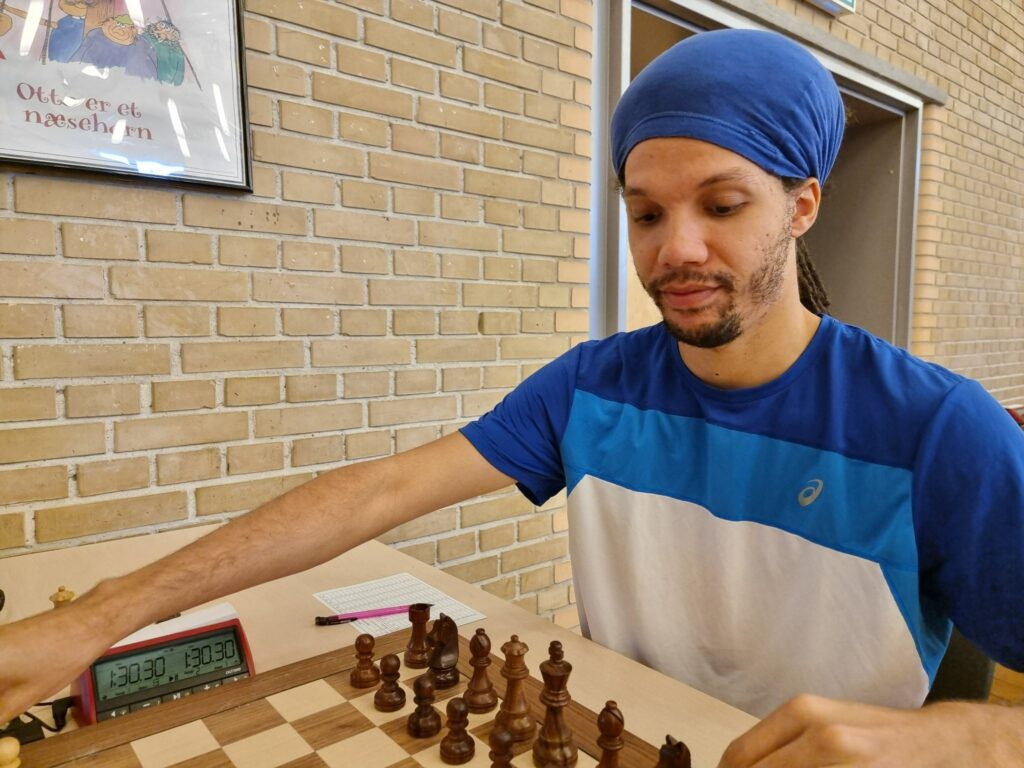 IM Kassa Korley preparing for the Round 9 game against GM Tiger Hillarp Persson. Photo by Dansk Skak Union.