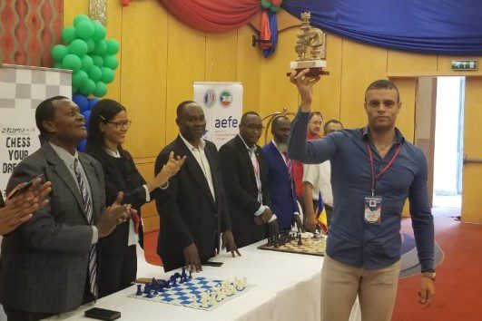 Sergio Periera of Sao Tome & Principe hoists the championship trophy
after winning Zone 4.3 Championship.