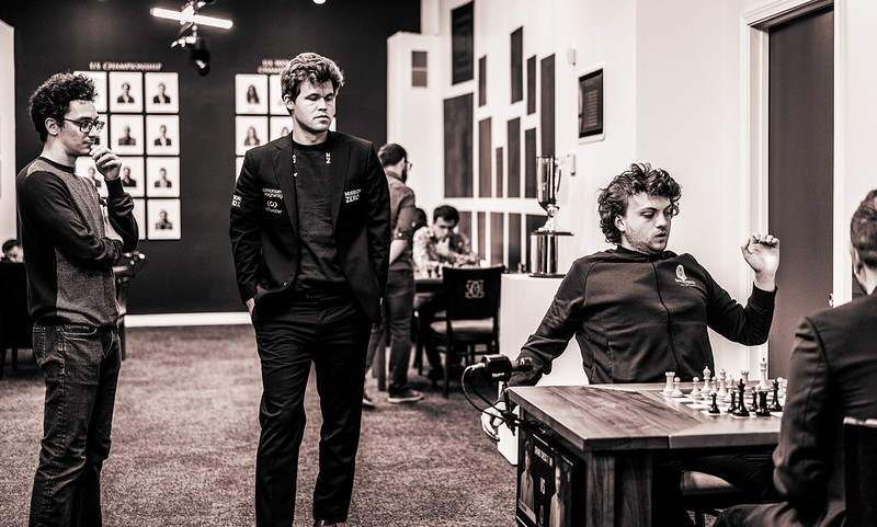 This is the round before the infamous Carlsen-Niemann game. Magnus Carlsen is pictured along with Fabiano Caruana watching Niemann's win against Shahkriyar Mamedyarov. Looking at the casual body language of Carlsen, there didn't seem to be any resentment toward Niemann despite his professed knowledge of his cheating past. The set of circumstances unfolding over the next 24 hours was indeed strange. Photo by Lennart Ootes.