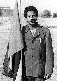 Cecil Lee posing with the Trinidadian flag at the 1976 Olympiad in Libya. Photo courtesy of T&T Chess Federation.