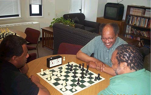 Frank Street (center) having a light moment with Willie 'Pop' Johnson (right) while playing blitz with FM Ronald Simpson.