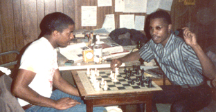 John Porter (R) showing a game to his cousin, Rodney Roberts.