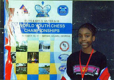 Darrian posing by the tournament advertisement.