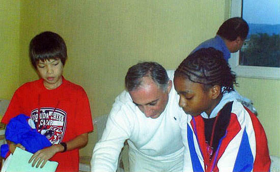 Darrian getting help from coach Armen Ambartsoumian while Ray Robson looks on. GM John Federowicz checks the Batumi scenery.