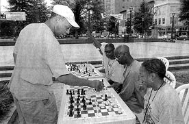 Frank Johnson takes on four opponents in a simultaneous exhibition. This picture was featured in the July 22nd issue of Atlantas major newspaper, The Atlanta Journal Constitution and was captioned Just some Pawns for the King. It is part of the 100-day initiative put on by the City of Atlanta. Copyright  2003, Atlanta Journal-Constitution.
