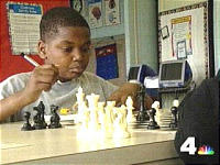 Student playing chess at the Moten Center in Washington, DC.