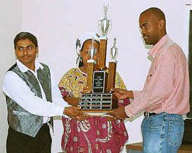 National Champion NM Matthews receives the National Championship Trophy from Mrs. Lorne and JCF Vice President, NM Mark Holness.