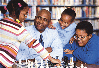 Coach Salome Thomas-EL, surrounded by his eager players from Vaux Middle School. (photo by Michael Ahearn)