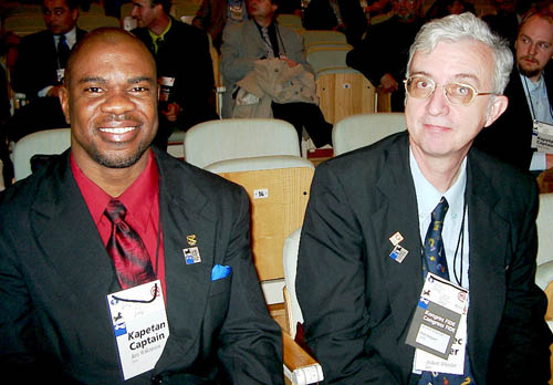 Jamaican Federation President Ian Wilkinson with NM Robert Wheeler at the opening ceremonies at the 2002 Olympiad in Bled, Slovenia. Copyright © 2002, Jerry Bibuld.