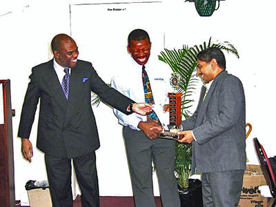 NM Shane Matthews (right) accepts his first place trophy from JCF President Ian Wilkinson (left) and National Master Geoffrey Byfield (center). 