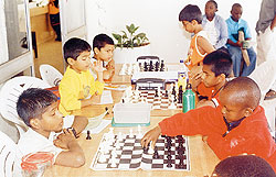 Peniel Weru Mburungo (right) moves against Viswanadh Gopa Kumar enroute to a gold medal during the Kenya National Youth Chess Championships.