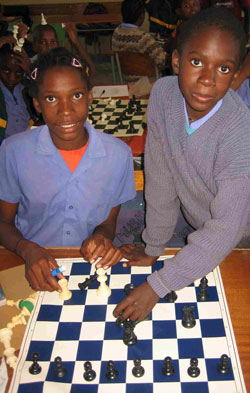 Two students in Otjituuo, Namibia graciously receive their new chess sets from North Carolina, USA.