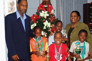 From Left- Mr. Andre Leveau-Communication Manager, Akeenie Murray, Keno Samuel, Lesley-Ann Nelson-Manager of Kid's Chess, Ronnie Nelson at front and Kevin Mahabir.