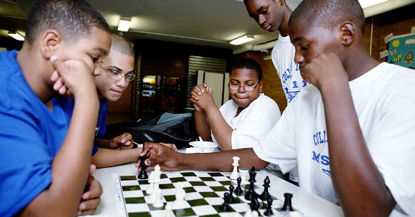 MS 118 students play a game of chess during the after-school programs called College Town, now in its fourth year. Photo by Enid Alvarez.