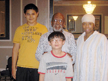 Ted Fagan (center) congratulates the winners: (L-R) Sharif Usenov, Charles Yang and Talisa Jackson.