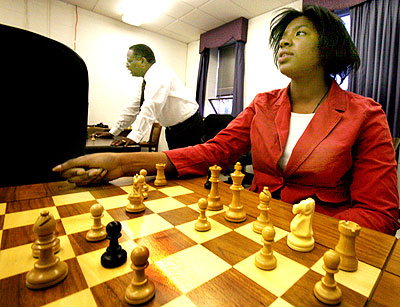 Dr. Sid Credle, center, the dean of Hampton Universitys business school, uses chess as a way to teach critical thinking. Nneka Uzoh, about strategy. Photo by John H. Sheally II/THE VIRGINIAN-PILOT.