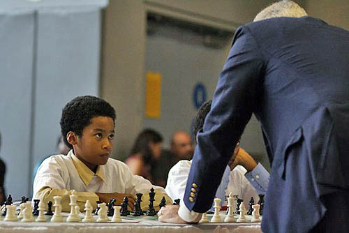 Jehron Bryant peering at the champ. Photo by Harlem Children's Zone.