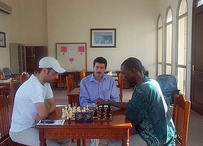 Zeyad Janahi playing Daaim Shabazz in Manama, Bahrain during a 2002 visit. IM Imed Abdelnabbi observes.