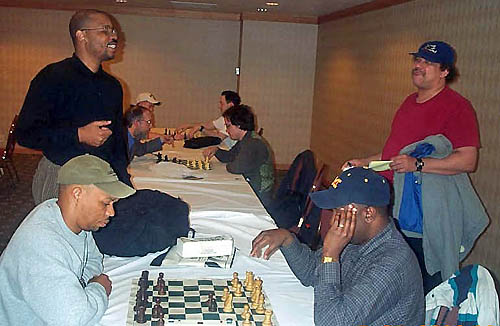 Tyrone Lee (standing right) chats with John Porter while Frank Johnson (seated left)blitzes with Kent Williams. Photo by Daaim Shabazz.