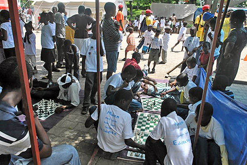 Haitian youth playing with FIDE donated chess equipment.