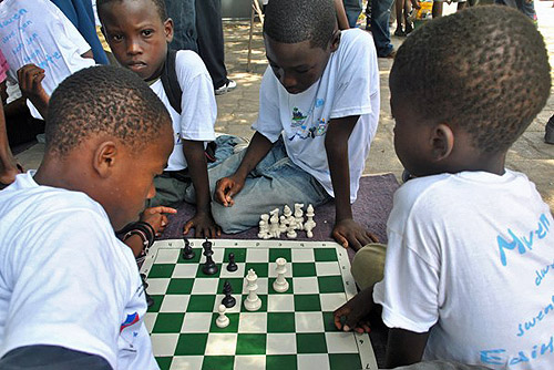 Haitian youth playing with FIDE donated chess equipment.