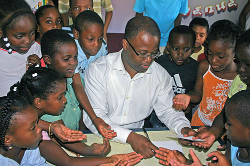 Maurice Ashley signing autographs for Guadeloupean schoolkids.