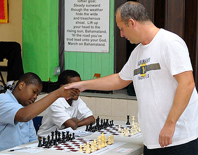 GM Norwood begins his game with scholastic player Sanni Carlos of St. Augustine College. Photo by Andre White.