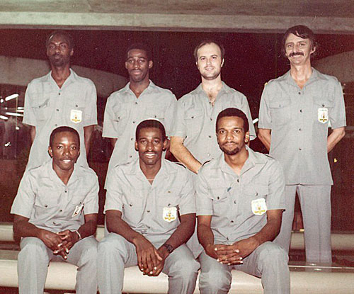 Barbados Airport Photo (1986) of the first Barbados Chess Olympiad squad. Back row, left to right: Othneil Harewood (First Reserve; also Board 3, 1998 Olympiad), David Dawson (board 4, 1986 & 1994 Olympiads), Andrew Chapman (Board 3), and manager Lindsay Bellhouse. Front row, left to right: Anthony Rolston (Second Reserve), Peter Dawson (Board 2, 1990 Olympiad), and yours truly (Board 1).